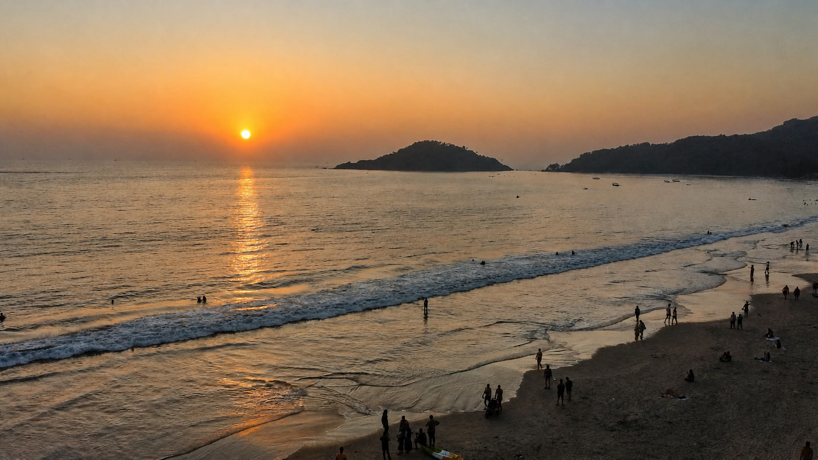 Sunset over Palolem beach and its forested headlands