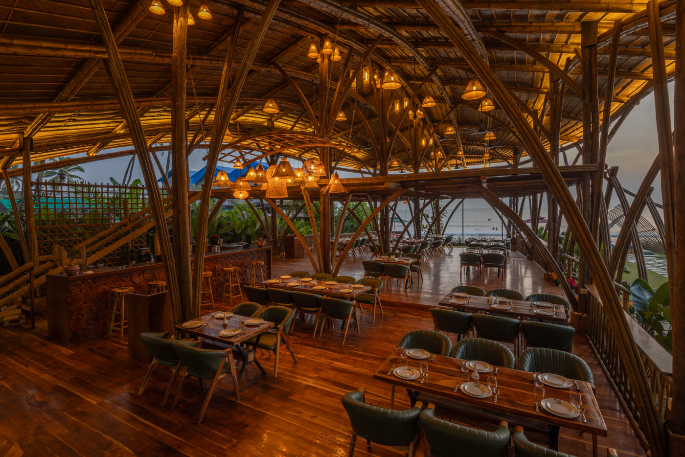 The Wave Goa's bamboo beachfront dining room set for service