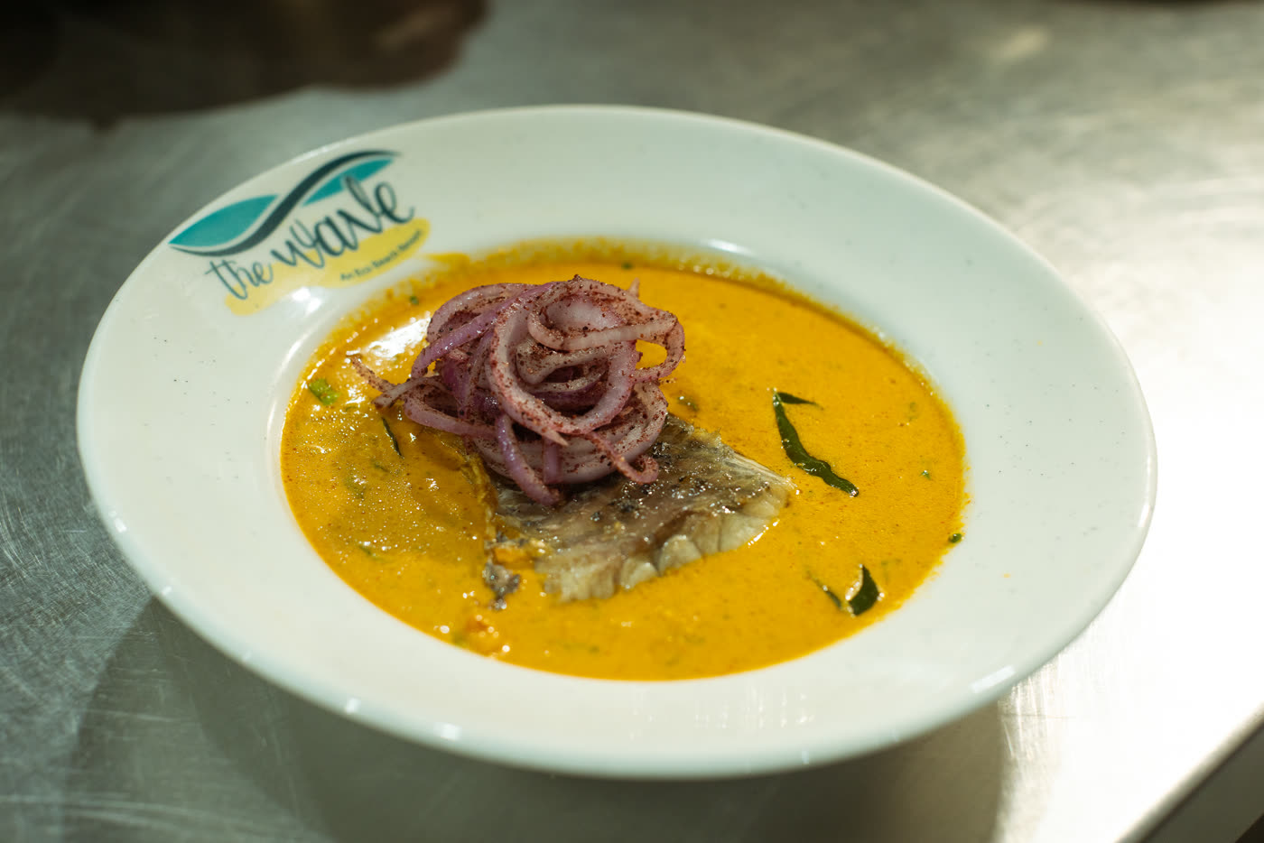 Fish curry served in a wide white bowl