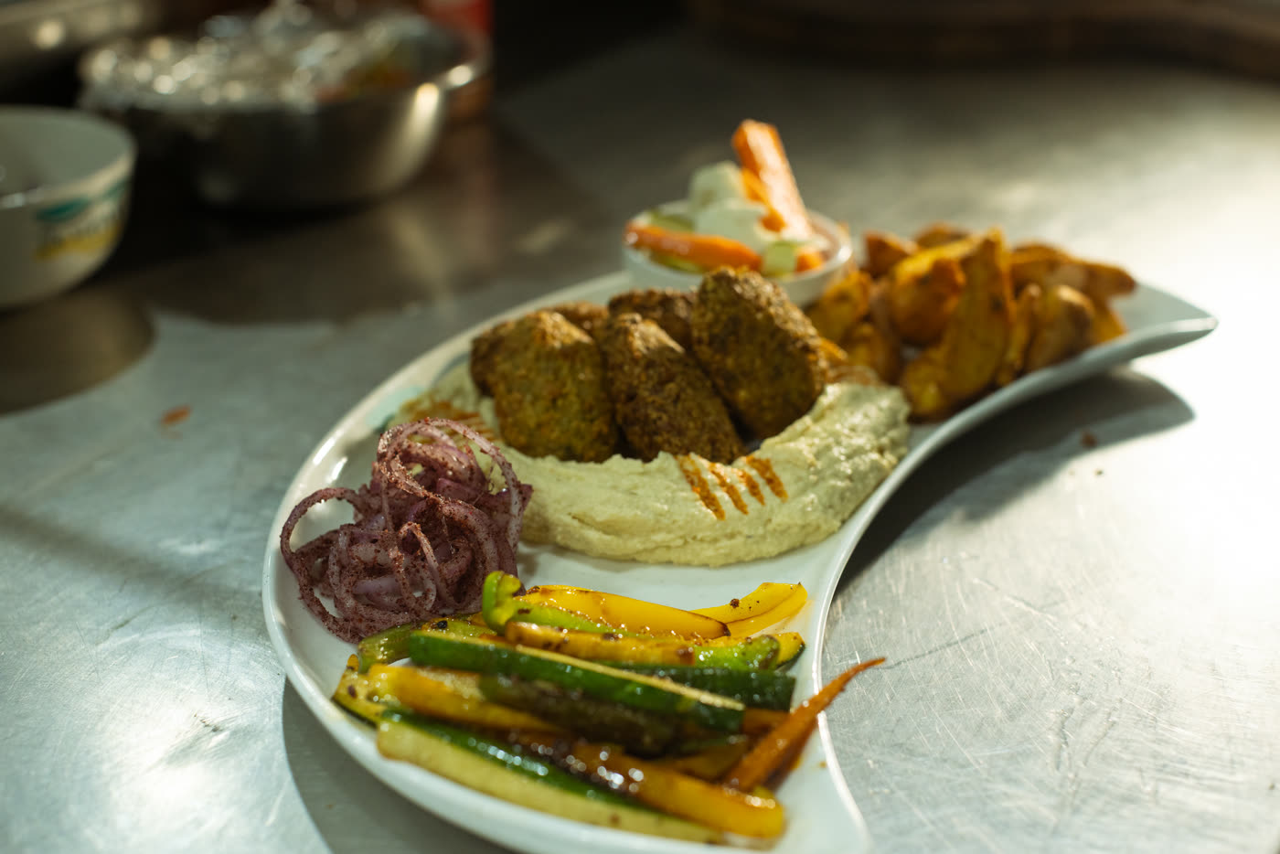 A freshly prepared plate with falafel, hummus and vegetables